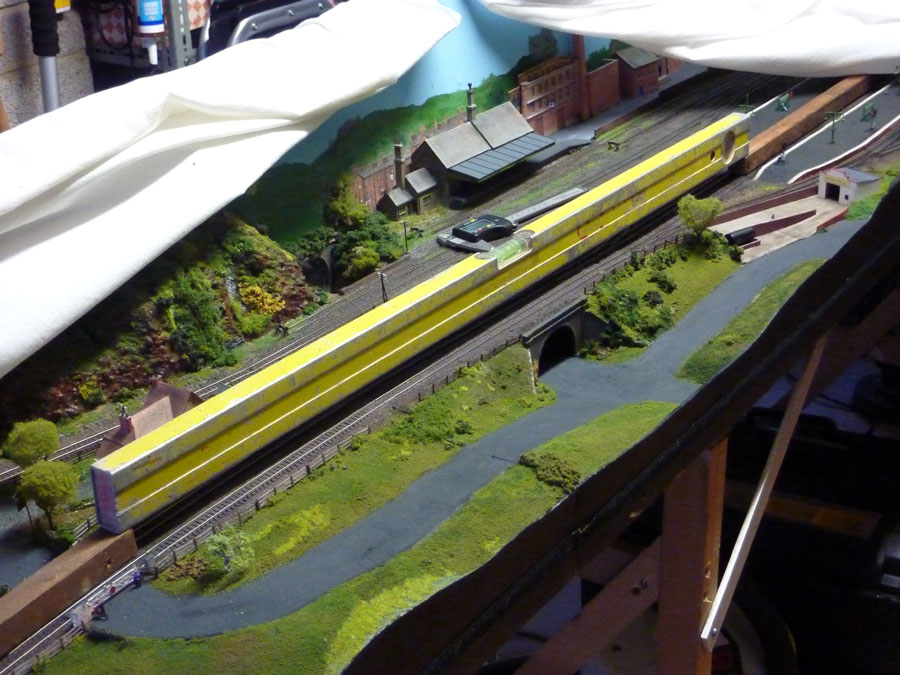 Surveying with the straight edge, the shadow tells the story of the hump, with it being clearly visible above the road bridge and falling away to the station on one side and the level crossing on the other - with a height change of around 7mm (1/4 inch) across about 100mm (four inches) on the station side.