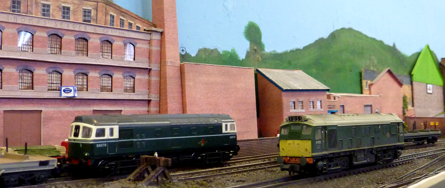 A Class 25 and a 33 are in the yard with some bogie bolster wagons for loading at Bailey Bros.